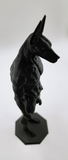 a sculpture of a dog on a black base