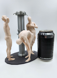 a couple of figurines standing next to a can