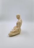 a statue of a man sitting on a surfboard